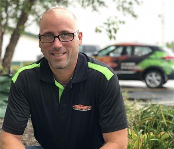 John Alessio in front of SERVPRO car