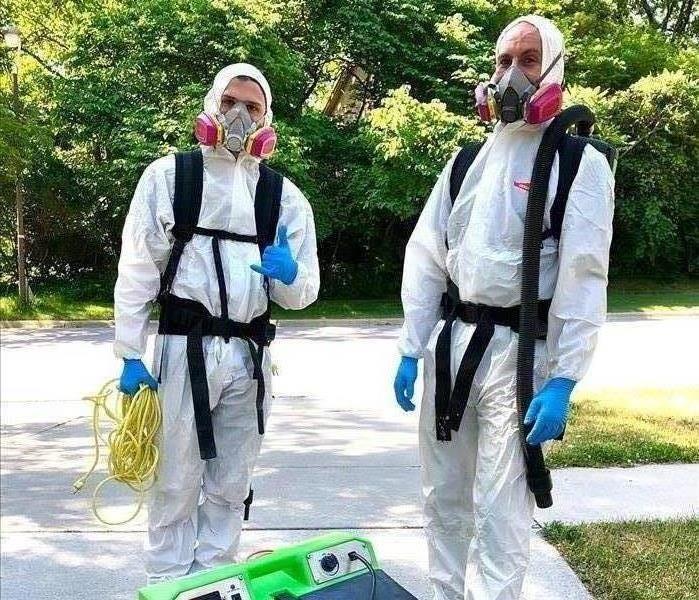 SERVPRO of Ames staff in disinfecting PPE
