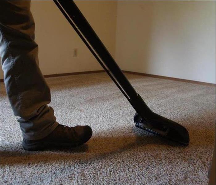 One of our employees cleaning a client's carpet