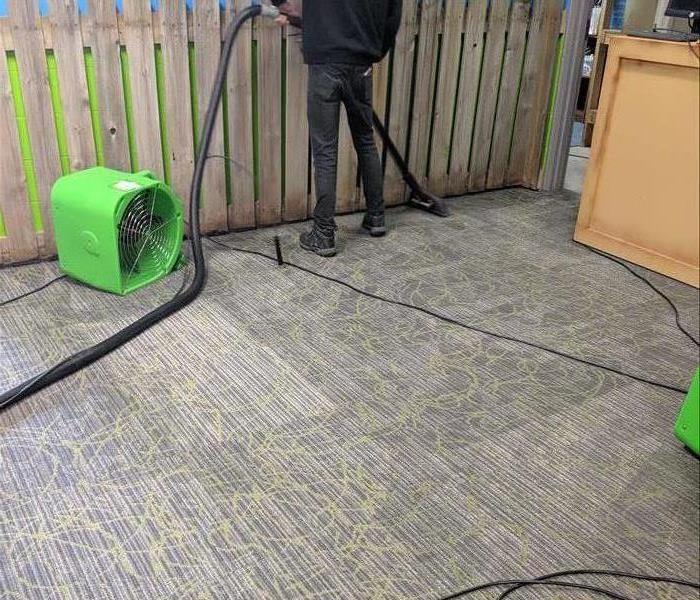 air mover drying carpet in area business after a storm
